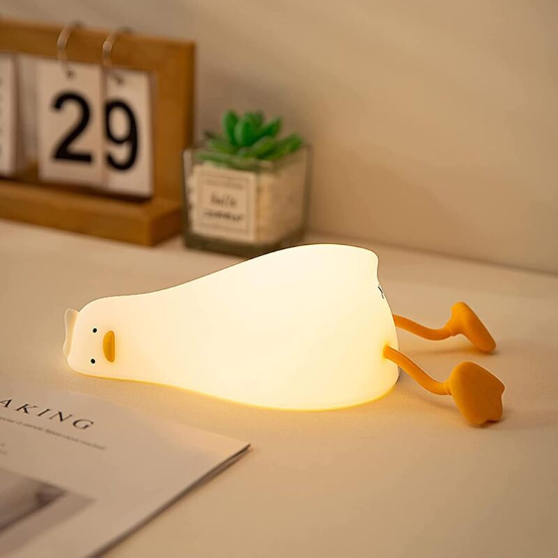 foto del prodotto lampada da notte a forma di anatra piatta sdraiata, lampada da notte per bambini dimmerabile a 3 livelli, lampada in morbido silicone a forma di