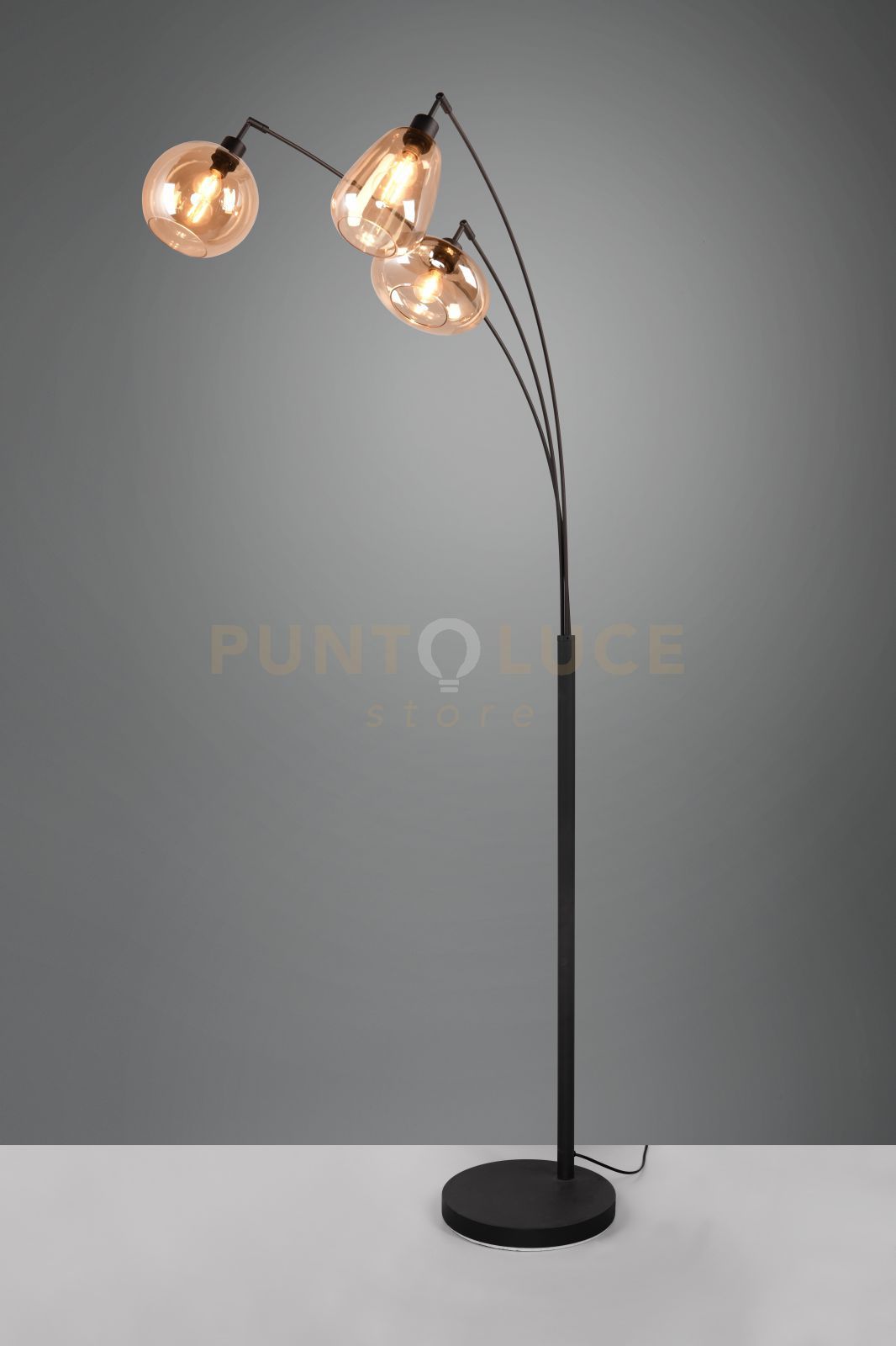 foto del prodotto lumina piantana metallo nero ad arco con 3 diffusori forme differenti in vetro ambra h. 200cm attacco e14