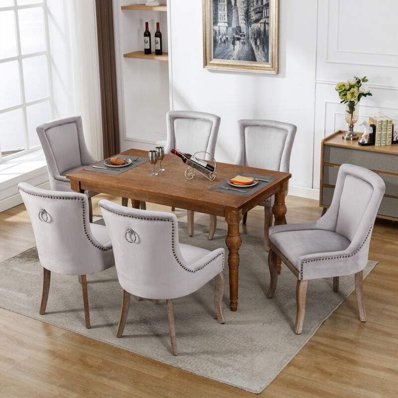 foto del prodotto set di 6 sedie da pranzo imbottite con finiture a borchie, gambe in legno massello, grigio